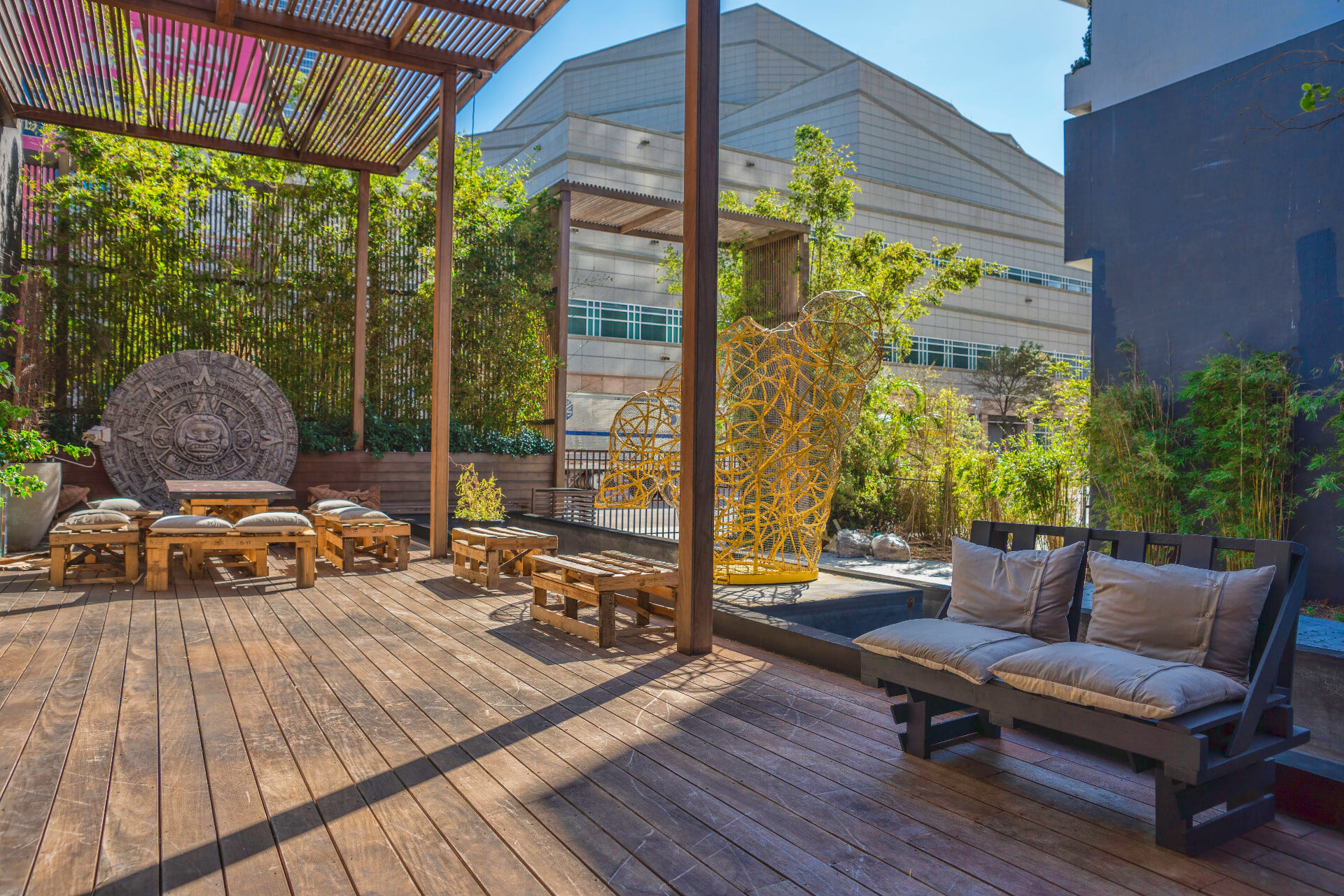 Outdoor terrace with golden wire sculpture and lounge seating