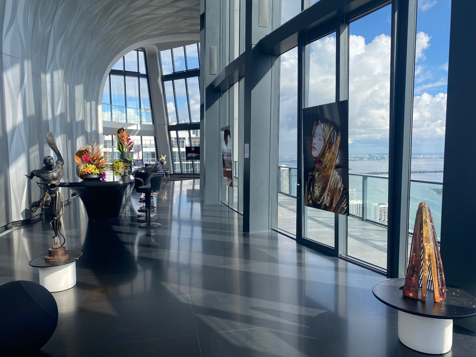 Sculpted gallery with bronze sculpture and suspended artwork at 1000 Museum, Miami
